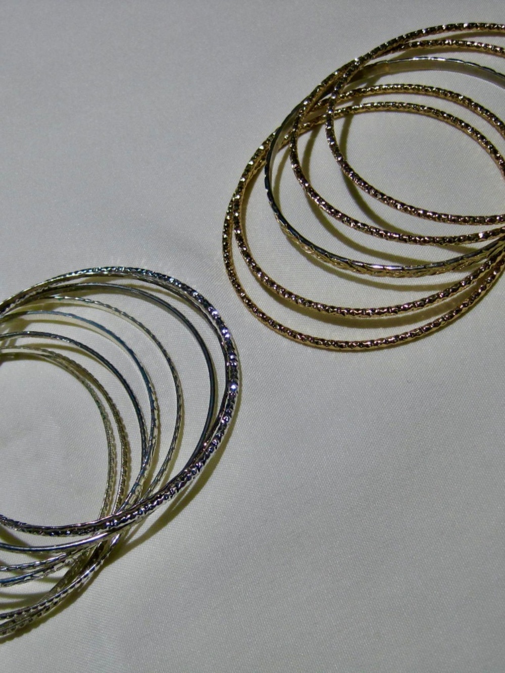Two Lots of Eight  Silver Tone Metal Bangles, Five Gold Tone Metal Bangles.